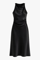 Elegant black maxi dress by Lumina Wear featuring a flattering silhouette, displayed on a model.