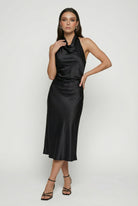 Elegant black maxi dress by Lumina Wear featuring a flattering silhouette, perfect for sophisticated occasions.