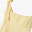 Yellow slim fit camisole tank top with bow detail by Lumina Wear, featuring a playful and stylish design.