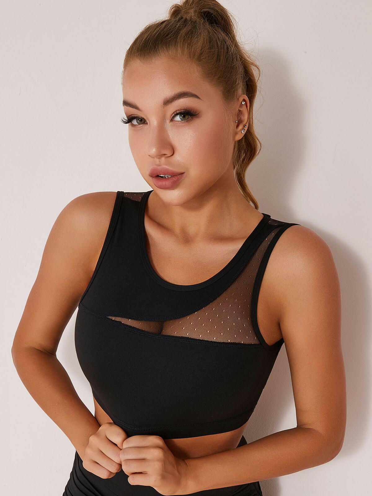 Black mesh yoga sports bra by Lumina Vancouver with a supportive fit and breathable fabric for active wear.