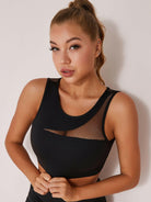 Black mesh yoga sports bra by Lumina Vancouver with a supportive fit and breathable fabric for active wear.