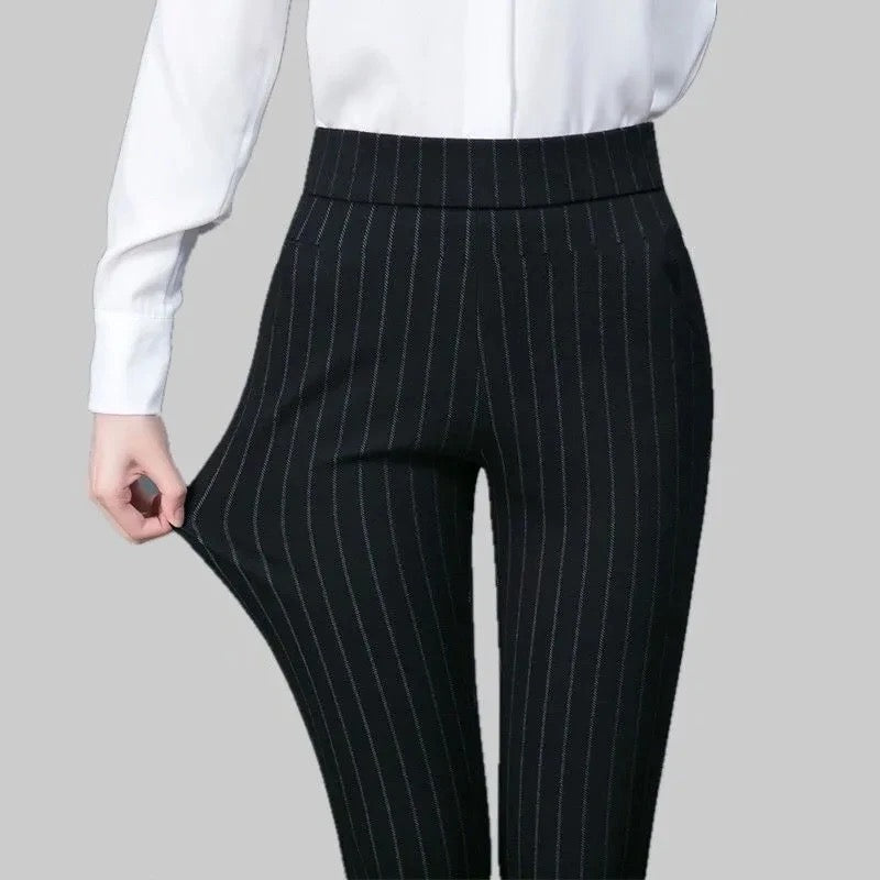 Elegant fitted black Lumina Wear trousers with stretch fabric, featuring subtle stripe details and a tailored silhouette.