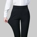 Elegant fitted black trousers with stretch fabric from Lumina Wear, featuring subtle stripe details and a sleek, tailored fit.