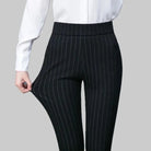 Elegant fitted black Lumina Wear trousers with stretch fabric, featuring subtle stripe details and a tailored silhouette.