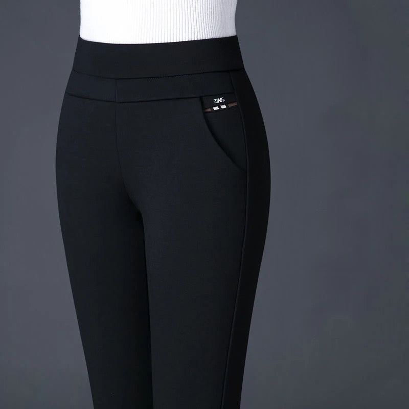 Elegant fitted black Lumina Wear trousers with stretch fabric and subtle stripe details, perfect for professional or casual wear.