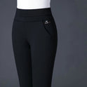 Elegant black fitted trousers with stretch fabric from Lumina Wear, featuring subtle stripe details and a tailored silhouette.