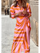 Lumina Vancouver Solana™ printed wrap dress in orange and pink fabric, featuring a stylish design and flattering fit.