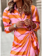 Lumina Vancouver Solana printed wrap dress in orange and pink, lightweight fabric, stylish design for casual or dressy occasions.