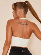 White Lumina Vancouver sports bra with solid color halter design, ideal for active wear and comfortable support.
