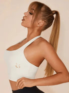White Lumina Vancouver solid color halter sports bra with supportive design and adjustable straps.
