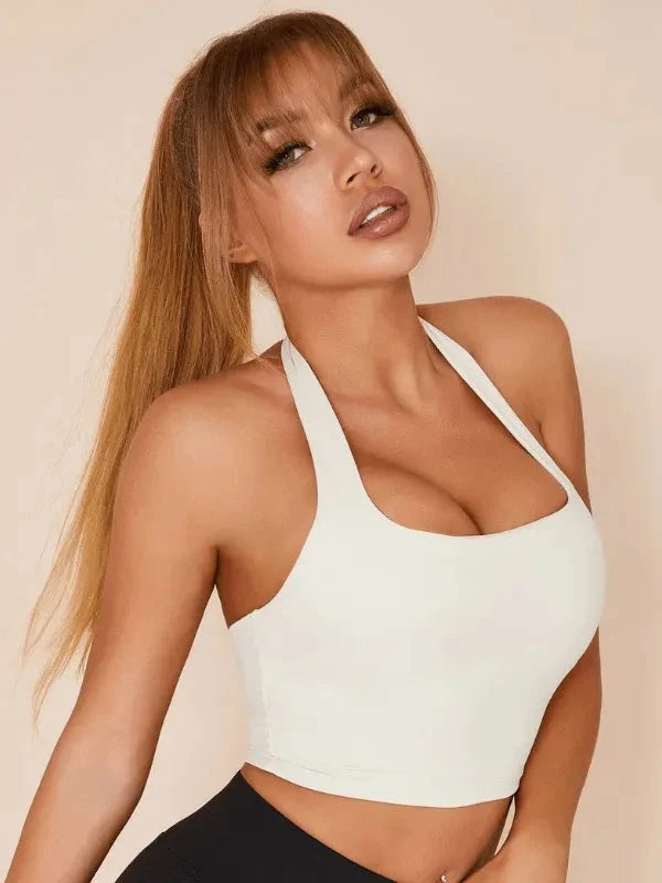 White Lumina Vancouver sports bra with a solid color halter style, designed for support and comfort during workouts.