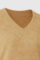 Lumina Wear Sophia cozy brown V-neck sweater with a flattering fit, shown in natural fabric and stylish design.