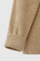 Lumina Wear Sophia cozy khaki knit sweater with V-neckline, featuring soft fabric and stylish fit, shown on a model.