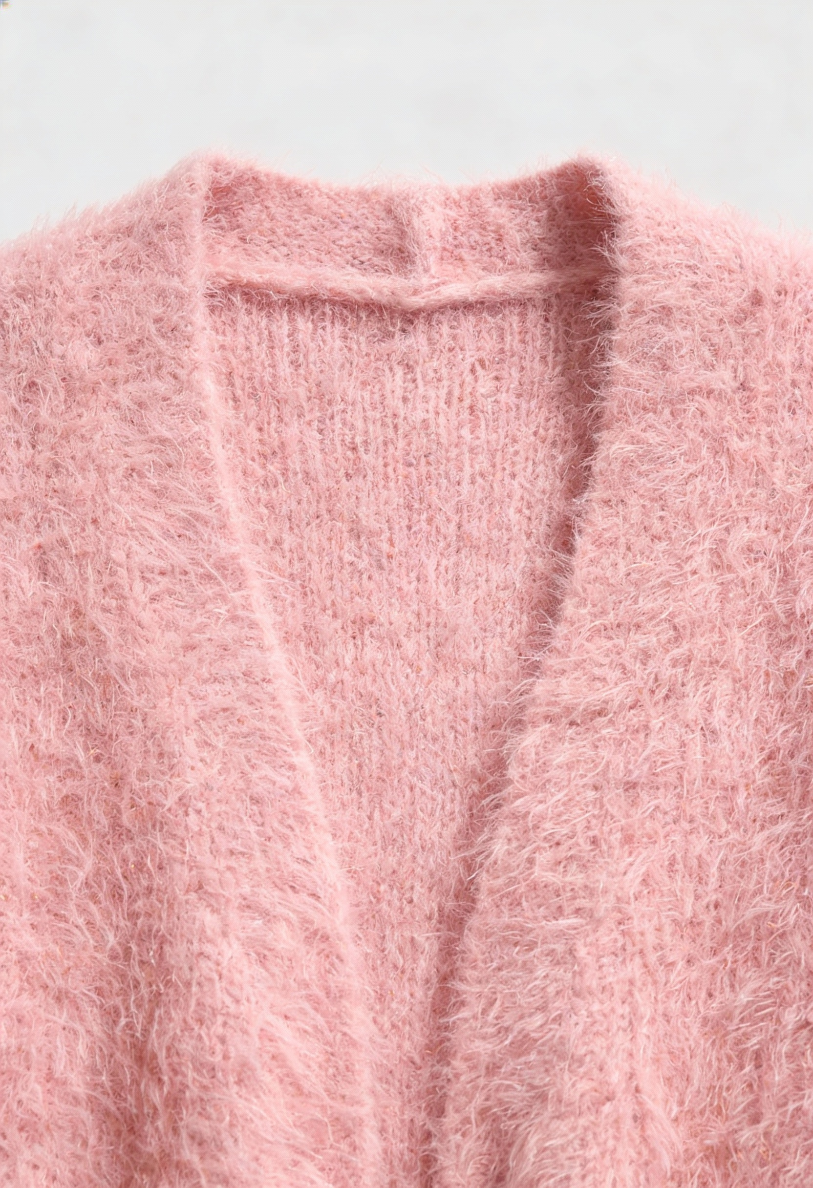 Pink knit cardigan from Lumina Wear's Sophia collection, cozy and versatile sweater featuring soft, stylish knit fabric.