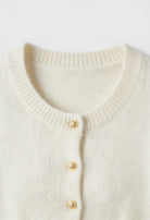 Sophia white cardigan sweater with ruffle details by Lumina Wear, cozy knit with stylish ruffle accents, perfect for casual wear.