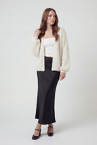 Sophia Lumina white knit cardigan with ribbed hem, cozy sweater featuring long sleeves and soft textured fabric.
