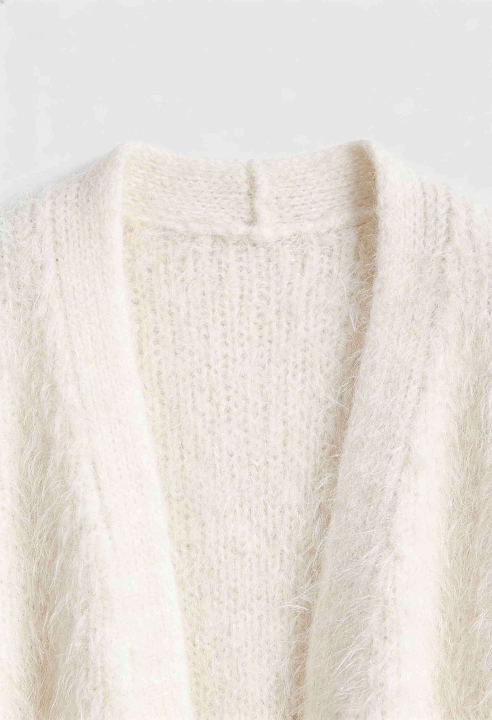 Lumina Wear Sophia cozy white knit cardigan with ribbed hem, featuring a soft, warm sweater style perfect for casual wear.