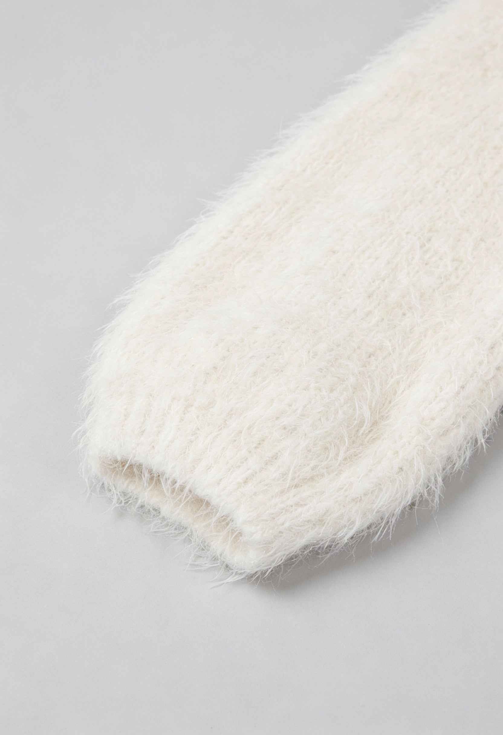 White knit cardigan named Sophia from Lumina Wear featuring a cozy design and ribbed hem, perfect for layered winter style.