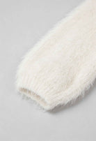 White knit cardigan named Sophia from Lumina Wear featuring a cozy design and ribbed hem, perfect for layered winter style.