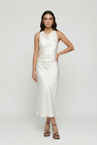 Elegant beige summer dress by Lumina Wear featuring adjustable fit and casual style, shown on a model.