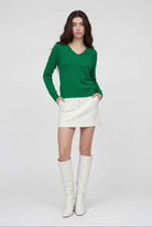 Lumina Wear Sophia green v-neck sweater with fitted silhouette, displayed on a model showcasing stylish, elegant women's knitwear.