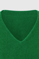 Lumina Wear Sophia green V-neck sweater with fitted silhouette, showcasing soft knit fabric and stylish design.