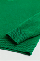 Elegant green Sophia V-neck sweater by Lumina Wear featuring a fitted silhouette, displayed on a neutral background.