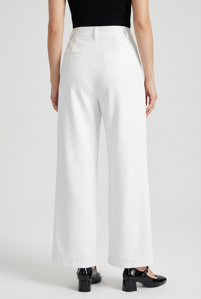 White high-waisted pleated trousers with stretch from Lumina Wear, showcasing elegant, tailored design and comfortable fit.