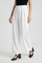White Sophia Lumina Wear high-waisted pleated trousers with stretch, tailored for a sleek, elegant look.