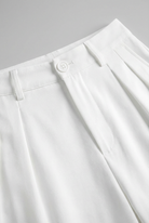 White Sophia Lumina Wear high-waisted pleated trousers with stretch, featuring a tailored fit and elegant design.
