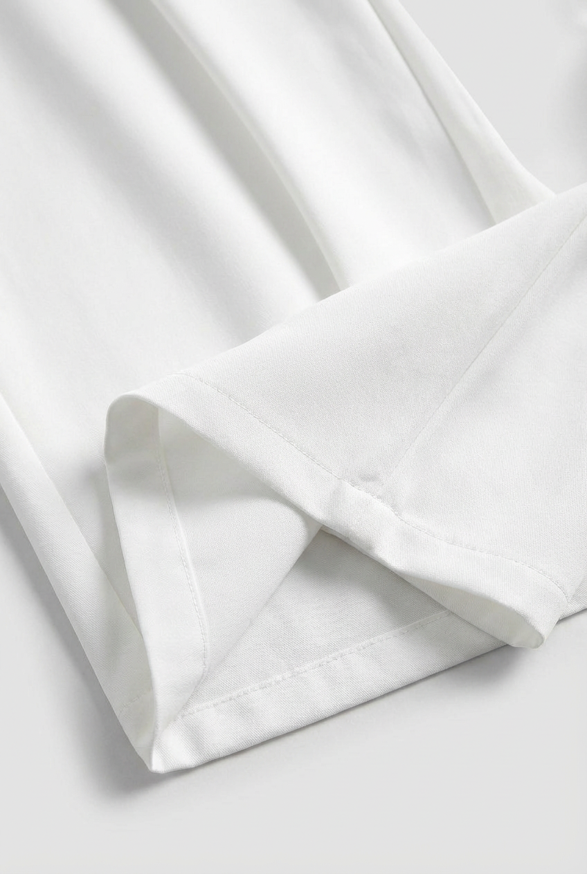 White Sophia high-waisted pleated trousers with stretch from Lumina Wear, showcasing tailored fit and elegant design.