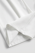 White Sophia high-waisted pleated trousers with stretch from Lumina Wear, showcasing tailored fit and elegant design.