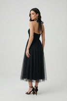 Elegant black long sleeve midi dress by Lumina Wear, featuring a flattering silhouette for women's fashion.