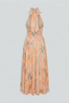 Elegant peach maxi dress by Lumina Wear featuring a flattering silhouette and flowing fabric, perfect for formal occasions.