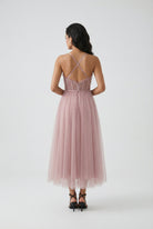 Elegant pink midi dress by Lumina Wear featuring a flattering silhouette, perfect for sophisticated occasions.