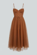 Elegant rust chiffon midi dress with ruffle trim by Lumina Wear, featuring a flowing silhouette and stylish detailing.