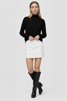 Sophia Lumina Wear slim fit black turtleneck sweater, close-up of the elegant, form-fitting sweater on a model.