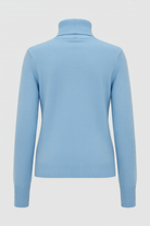Blue Sophia Lumina Wear slim fit turtleneck sweater, showing its cozy knit and fitted design in a close-up shot.