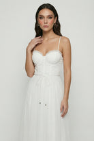 Elegant white midi dress by Lumina Wear featuring a flattering silhouette and sophisticated design.
