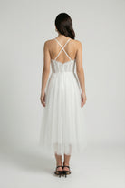Elegant white midi dress by Lumina Wear featuring a flattering silhouette, perfect for sophisticated occasions.
