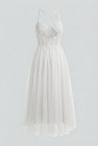 Elegant white midi dress from Lumina Wear featuring a flattering silhouette, perfect for stylish occasions.
