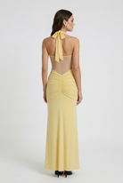 Elegant yellow halter dress with ruched detail from Lumina Wear, featuring a fitted style and stylish design.