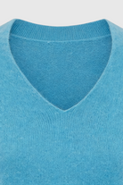 Light blue V-neck women's sweater from Lumina Wear featuring a fitted silhouette, displayed on a neutral background.