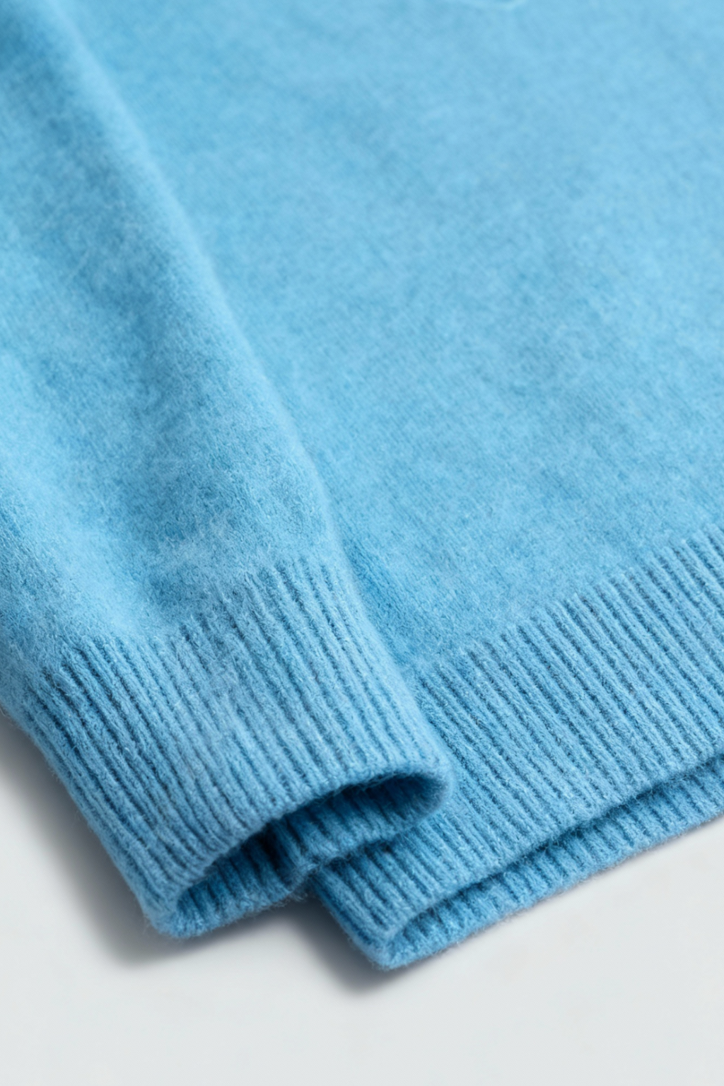 Light blue V-neck women's sweater by Lumina Wear, fitted silhouette, showcasing a cozy, stylish sweater for women.