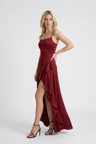 Sophia flowing red maxi dress with asymmetric hem by Lumina Wear, featuring a graceful silhouette and elegant design.