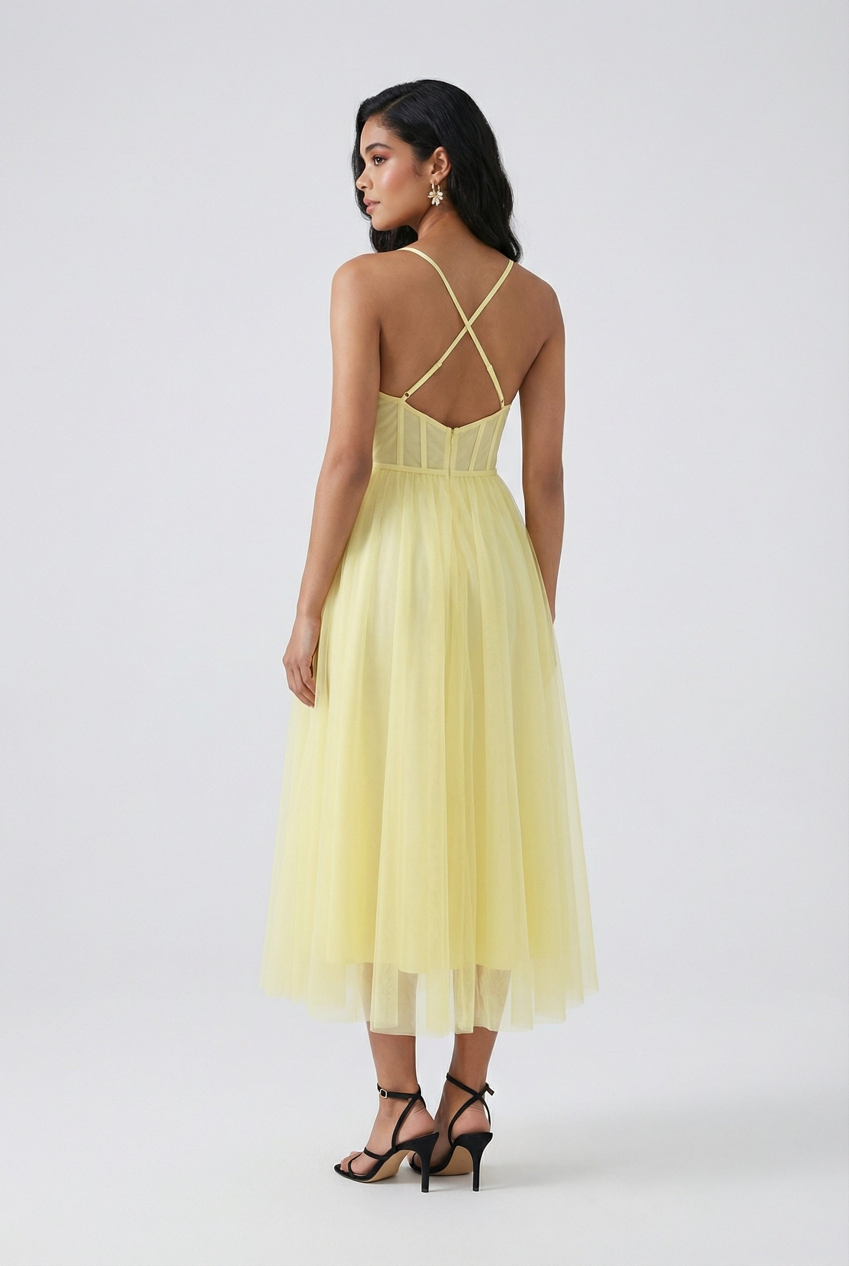 Lumina Wear Sophia yellow midi dress with flowing fabric and elegant design, showcased on a model.