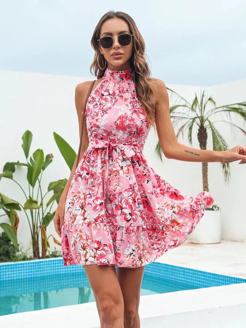 Pink floral halter neck mini dress by Lumina Vancouver, featuring a fitted silhouette and delicate floral print.