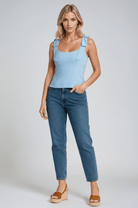 Light blue Sophia Lumina Wear women's crop top with playful bow detail and zipper closure, style for casual or trendy outfits.