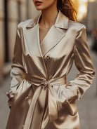 Sophia trench coat in refined champagne satin by Lumina Vancouver, showcasing elegant, smooth fabric and classic design.