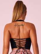 Black Lumina Vancouver sports bra with Roman knot halter design and beautify back, perfect for active wear.